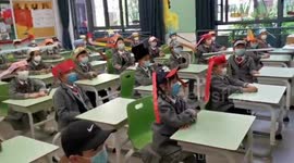 Chinese pupils wear one-metre-wide hats to keep safe distance with others
