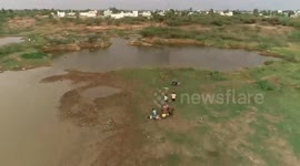 Drone footage; Young people enjoying fishing in the lake despite the curfew amid Covid 19 in Southern India.