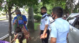 Prisoners released due to coronavirus regulations hand out masks to motorists in Indonesia