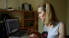 Girl playing music with a digital synthesizer in her quarantine room in Madrid