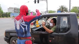 Thai man dresses up as Spider-Man to sell flowers to motorists during coronavirus pandemic