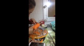 Vietnamese woman sculpting the corn from a carrot