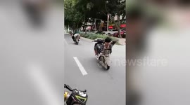 Police fine Chinese biker seen driving while slouched back not holding handlebars