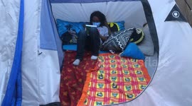 2nd Grade Boy studying in a backyard tent with Covid-19 mask