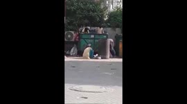 Daily wages Labourers picking food and vegetables from Waste Box