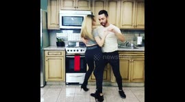 US couple getting through quarantine by dancing in kitchen