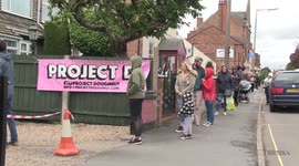 Customers queue down the street to buy doughnuts