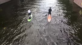 Boys chatting while supping through empty Amsterdam canals