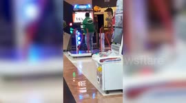 Delivery rider plays on arcade dance machine on his break