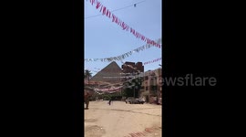Pyramids of Egypt seen behind Ramadan flags in Cairo
