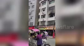 Neighbours catch boy jumping from first floor burning flat in central China
