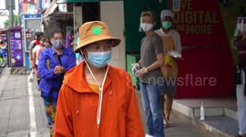 Thai people receive food donations