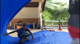 Kids stuck at home in Indonesia during lockdown 'surf' using skateboards and tarpaulin