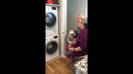 Bored couple in quarantine watching their dryer