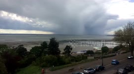 Timelapse shows dark rain clouds drift over the Thames estuary