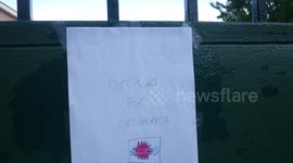 A school is closed due to coronavirus in Madrid and there is an announcement made by a child at the door.