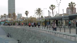 people out along the beach promenade for the first day of exercise after 7 weeks of lockdown in barcelona, spain