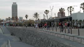 people out along the beach promenade for the first day of exercise after 7 weeks of lockdown in barcelona, spain