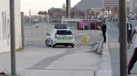 police patrol the people out along the beach promenade for the first day of exercise after 7 weeks of lockdown in barcelona, spain