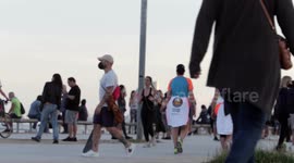 people out along the beach promenade for the first day of exercise after 7 weeks of lockdown in barcelona, spain