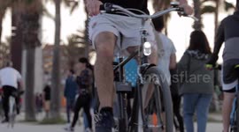 people out along the beach promenade for the first day of exercise after 7 weeks of lockdown in barcelona, spain