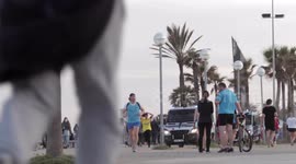 people out along the beach promenade for the first day of exercise after 7 weeks of lockdown in barcelona, spain