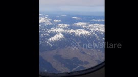 view of snowy mountains from a plane