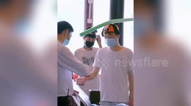 Tourists given long balloon hats to keep distance after coronavirus outbreak