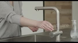 Woman washing hands with soap and hot water in kitchen, hygiene, Coronavirus pandemic prevention
