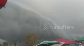 Huge wall-like cloud towers over market in southern Thailand