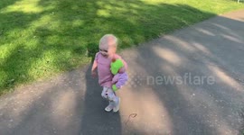Baby/toddler running knocked over by bike and falls over