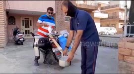 Indian man uses social distancing 'milk gun' to serve customers