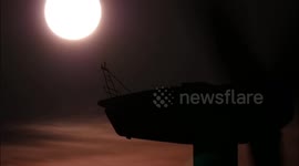 Full Flower Super Moon rising over spinning wind turbines - time-lapse Thursday 7th May 2020
