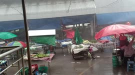 Tropical storm batters market in northern Thailand as temperatures hit 40C
