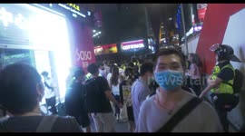 Hong Kong protesters chant slogans in Mong Kok, despite heavy police presence