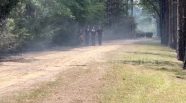 Firemen emerge from burning woods to fight the Florida fires