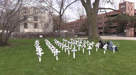 Rows of crosses placed as a memorial to 50 senior who have died during COVID 19 at retirement home near Toronto Canada