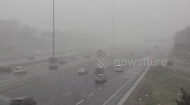 Heavy snow and blowing snow with whiteout conditions on highway 401 as polar vortex cold weather hits Toronto in rare May snow and cold weather event giving people more reason to want to stay home during COVID 19 quarantine