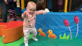 Baby takes first steps and falls over