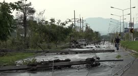 Driver injured after tropical storm pulls electricity lines onto cars in Thailand