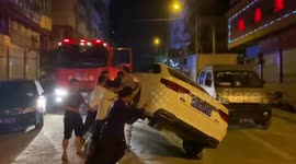 Chinese residents flip car onto its side to clear path for fire engine
