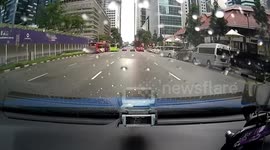 Drivers baffled by topless man roller-skiing through rush hour traffic in Singapore