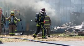 Florida Firefighters cut through a burning building next door to an elementary school during a red flag day due to drought conditions and high winds