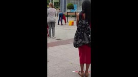 Weight it out: Woman performs exercise routine including PUSH-UPS while queuing at London shopping centre