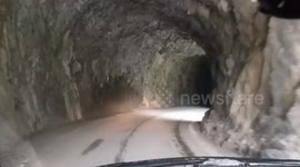 Dashcam - Driving down spectacular narrow Derborence Tunnel road in swiss Alps