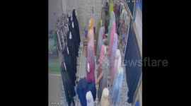 Indonesian shoplifter caught on CCTV stealing headscarf and clothes in a boutique shop