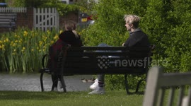 young couple meet on bench after lockdown