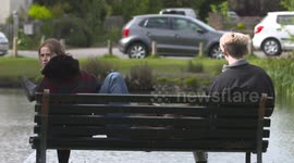 young couple meet on bench after lockdown
