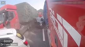 Car crushed in between two trucks after one loses control on Chinese highway