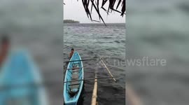 Fishermen rush back to shore as Typhoon Ambo makes landfall in the Philippines